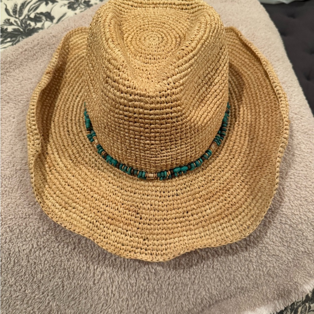 Packable, adjustable straw hat w wood bead band.